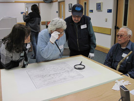Elders from Allakaket and Alatna take a closer look at the Koyukon Native Place Names Map at the Alaska and Polar Regions Collections and Archives, Elmer E. Rasmuson Library, November 11, 2009.