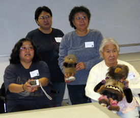 Debbie Nictune, Nancy Ambrose, Lulu James and Florence Nictune holding dolls made in Evansville at the University of Alaska Museum of the North, November 12, 2009.