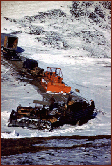 Image of heavy machinery getting of the main Dawson Road