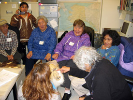 Elders from Anaktuvuk Pass look at the first caribou skin mask made by Bob Ahgook and Zacharias Hugo at the University of Alaska Museum of the North, November 5, 2008.