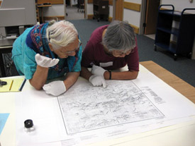 Rose Ambrose and Lillian Simon taking a closer look at the Koyukon Native Place Names map in the Alaska and Polar Regions Collections and Archives, November 10, 2010.
