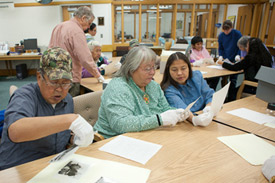 Elders from Hughes and Huslia identify people in historic photographs at the Alaska and Polar Regions Collections and Archives, Elmer E. Rasmuson Library, November 10, 2010.
