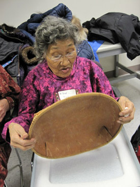 Mildred Black examines a birch bark basket at the University of Alaska Museum of the North, November 16, 2011.