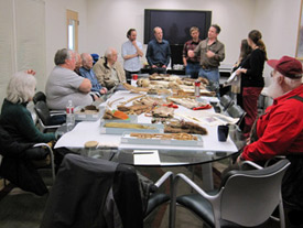 Jack Reakoff (back, right) talks about some of the material seen at the University of Alaska Museum of the North, March 28, 2012.