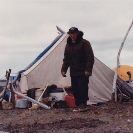 Warren Neakok in Front of Tent